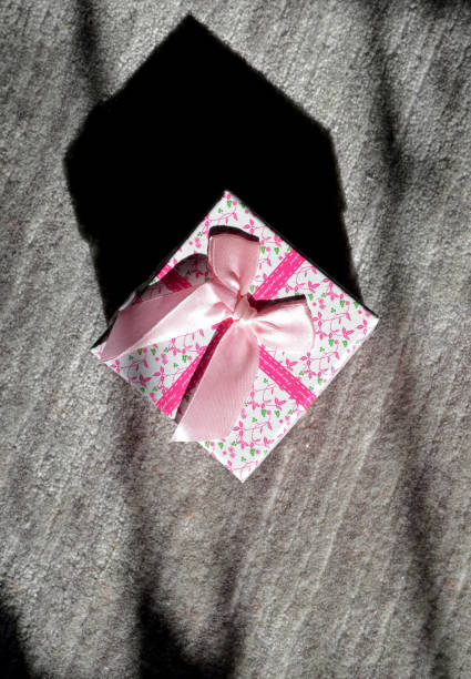 istock gift box with pink ribbon on background 1208561333