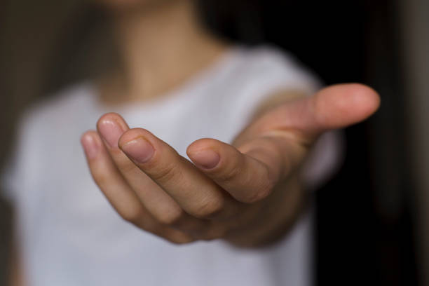 istock young woman's hand reaching out 1208561422