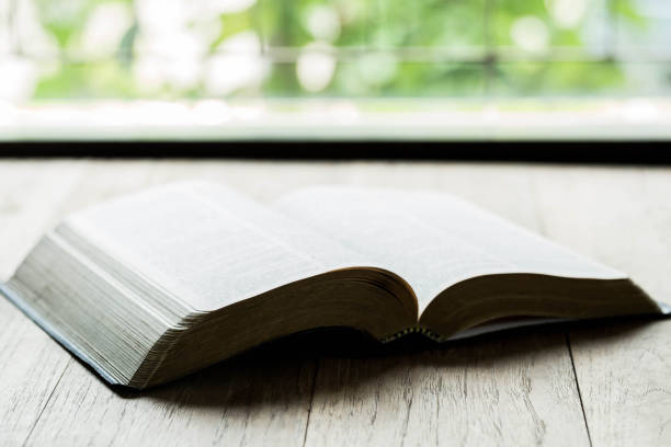 istock Holy Bible on a wooden table with morning 1208562305