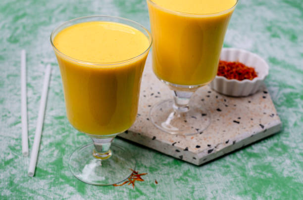istock Yellow smoothie in glass 1208562369