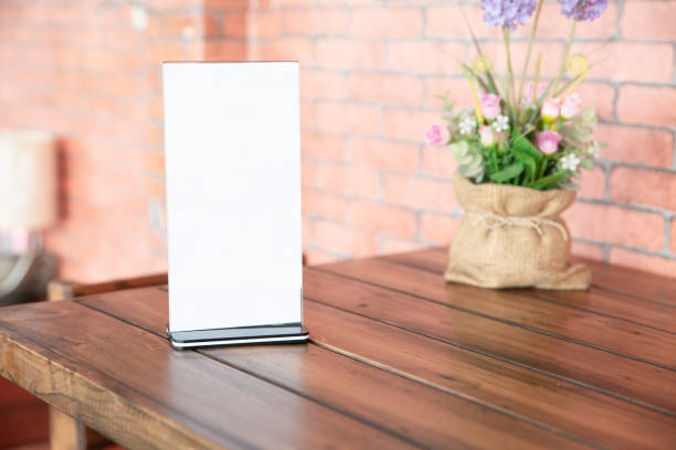 Menu frame standing on wood table Menu frame standing on wood table in coffee shop. space for text. restaurant table card stock pictures, royalty-free photos & images