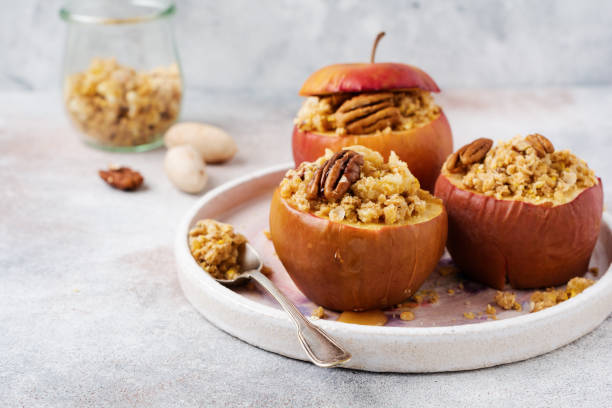 istock Baked Apples Stuffed with pecans, cinnamon, streyzel and honey on old concrete light background. Rustic stale. 1208562628