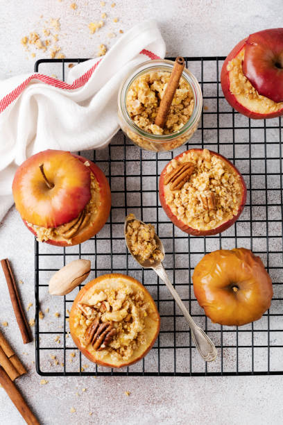 istock Baked Apples Stuffed with pecans, cinnamon, streyzel and honey on old concrete light background. Rustic stale. 1208562699