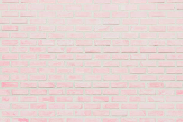 istock Pastel Pink and White brick wall texture background. Brickwork or stonework flooring interior rock old pattern clean concrete grid uneven brick design stack. Home or office design backdrop decoration. 1208562739