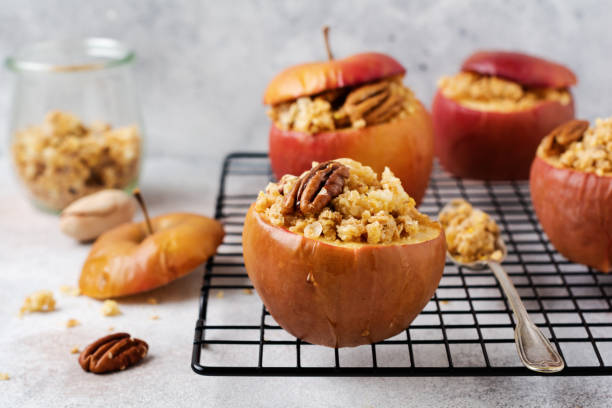 istock Baked Apples Stuffed with pecans, cinnamon, streyzel and honey on old concrete light background. Rustic stale. 1208562831
