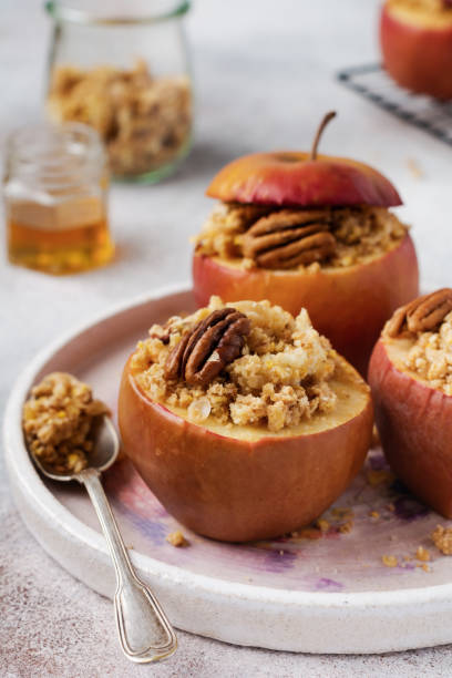 istock Baked Apples Stuffed with pecans, cinnamon, streyzel and honey on old concrete light background. Rustic stale. 1208562954