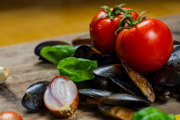 A plate of succulent clams swimming in a savory sauce takes center stage on the table at a family gathering.