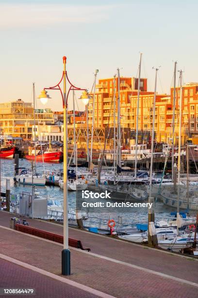 Evening View Of Scheveningen Harbour With Boats Apartment Buildings Bars And Restaurants In The Hague Stock Photo - Download Image Now