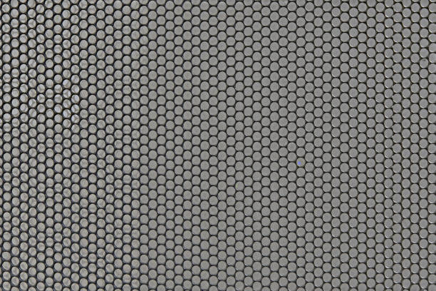 istock Metal background with round holes perforation, net of circles texture. Front view 1208567433