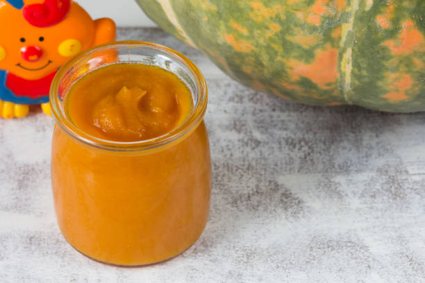 istock Pumpkin puree in glass jar on the white background 1208567841