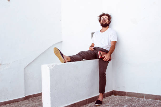 istock erudite man person with glasses and beard is sitting 1208567933