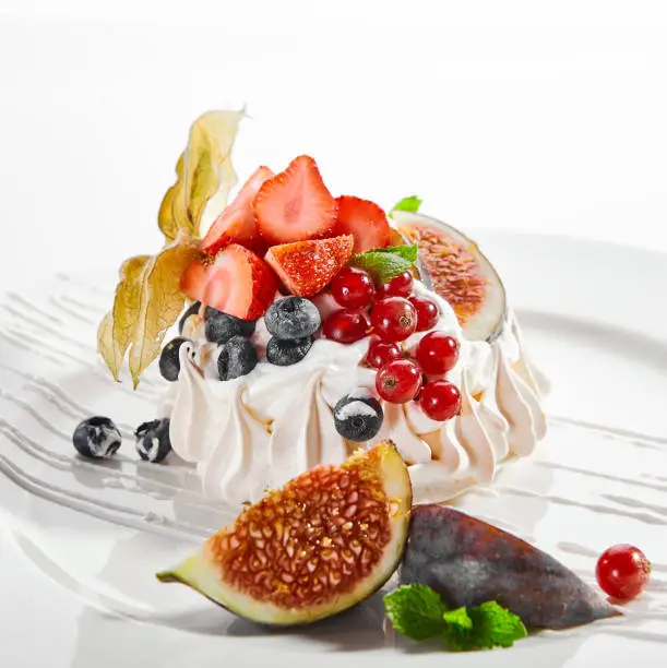 Photo of Pavlova dessert in white plate