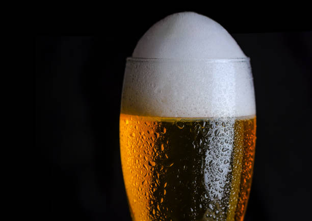 istock Amber beer on a dark background. Foam hop drink 1208568812