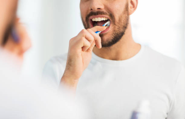 istock close up of man with toothbrush cleaning teeth 1208569257