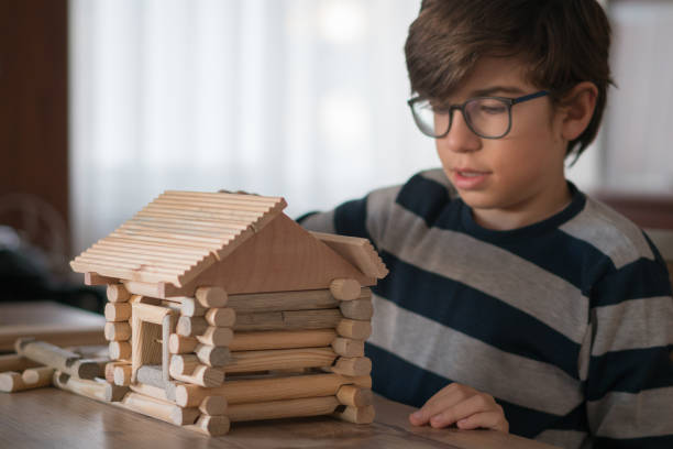 istock Happy  Boy playing  with wood house 1208572880