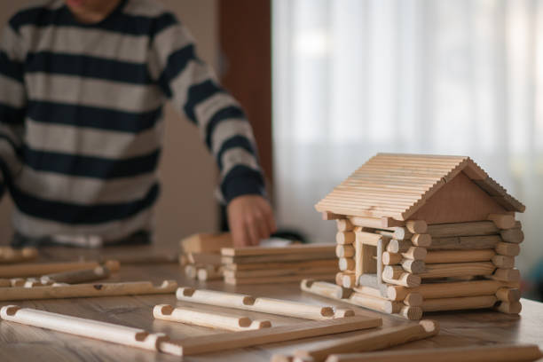 istock Happy  Boy playing  with wood house 1208573440