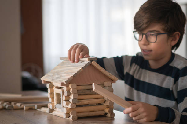 istock Happy  Boy playing  with wood house 1208573620