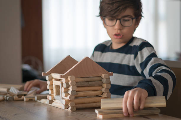 istock Happy  Boy playing  with wood house 1208573939