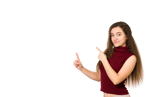 Cute young teenager holding hand showing ads, isolated over a white background