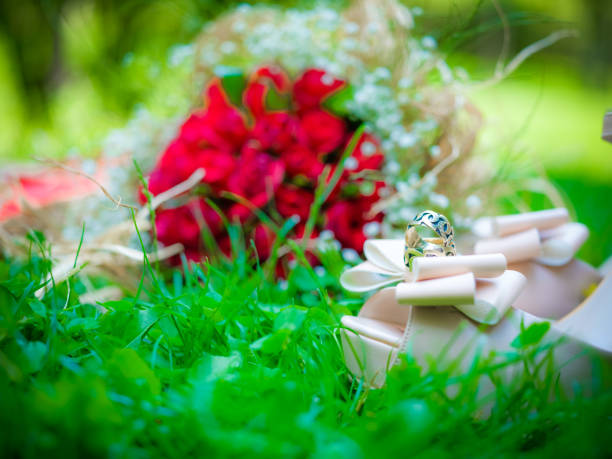 bridal bouquet, shoes and rings photos on greenery outdoors