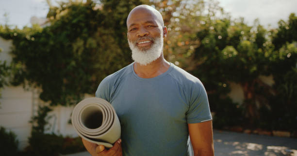 Staying fit is vital to me Cropped portrait of a happy senior man standing alone before a yoga session in his back garden posture photos stock pictures, royalty-free photos & images