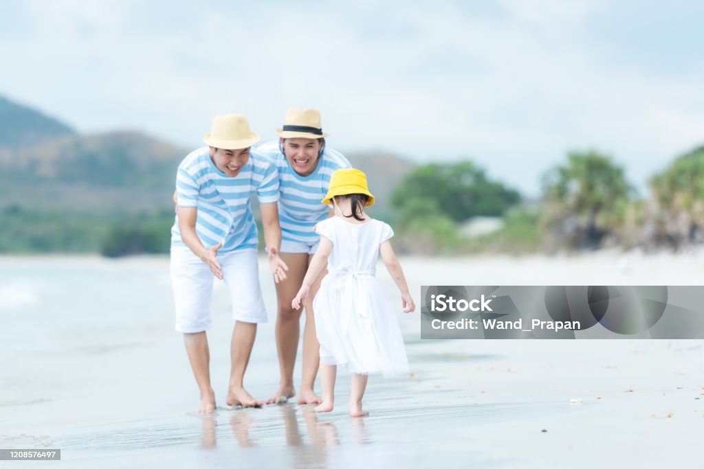 Happy family summer sea  beach vacation. Asia young people lifestyle travel enjoy fun and relax in holiday. Travel and Family Concept Active Lifestyle Stock Photo