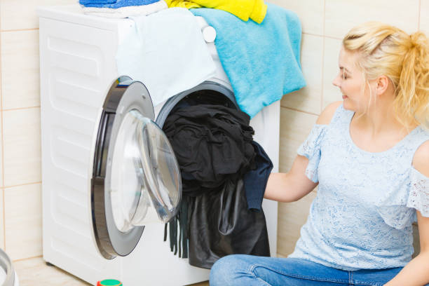 istock Woman washing black color laundry 1208576633