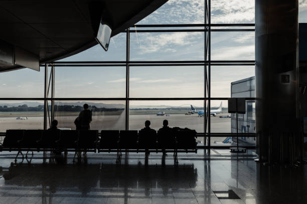 istock People waiting for their flight at the airport 1208576750