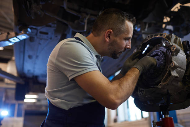 istock Auto Mechanic Repairing Car on Lift 1208577168
