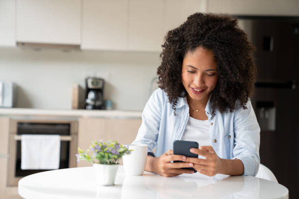 istock Happy woman at home using app on her smart phone 1208577361