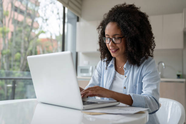 istock Happy woman working online at home 1208577882