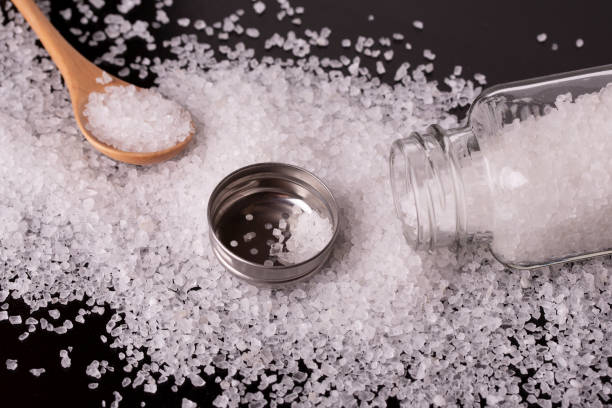 istock Salt shaker spoon and salt close-up. Open salt shaker. 1208578219