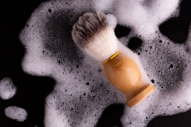 istock Brush for applying foam on a black background. 1208578292
