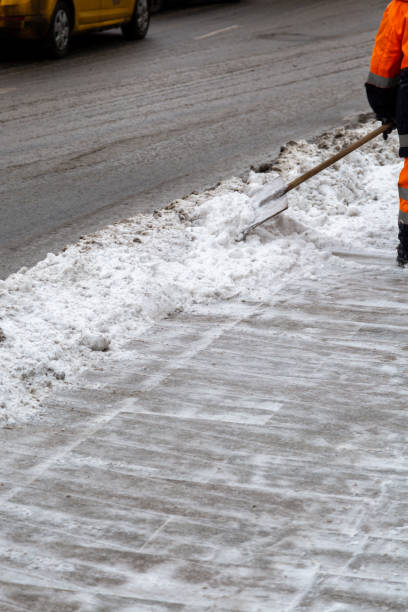 istock Worker sweeping snow from road in winter, Moscow, Russia 1208578611