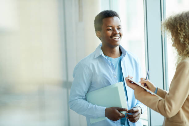 istock Young African-American Man Talking to Colleague 1208579767