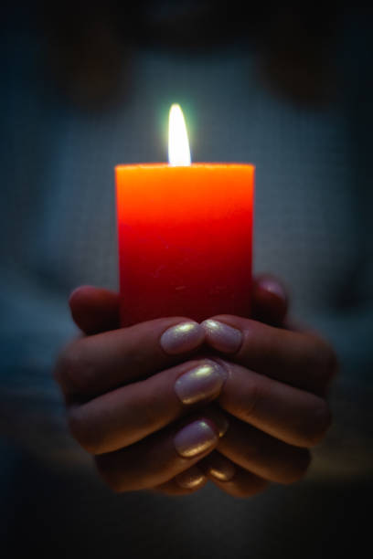 istock Red Candle in Female Hands 1208582754