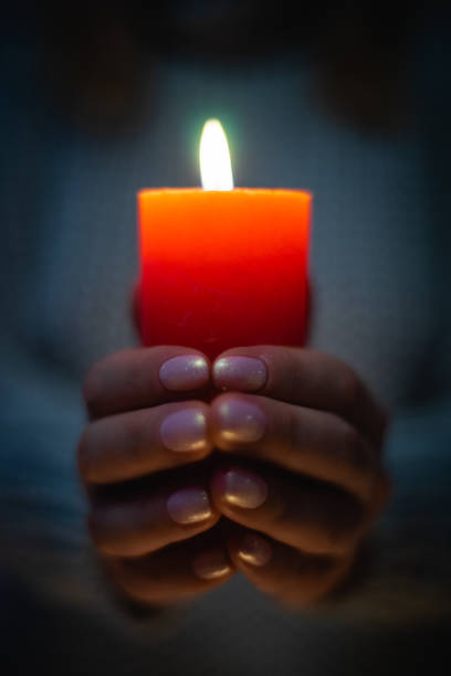 istock Red Candle in Female Hands 1208582759