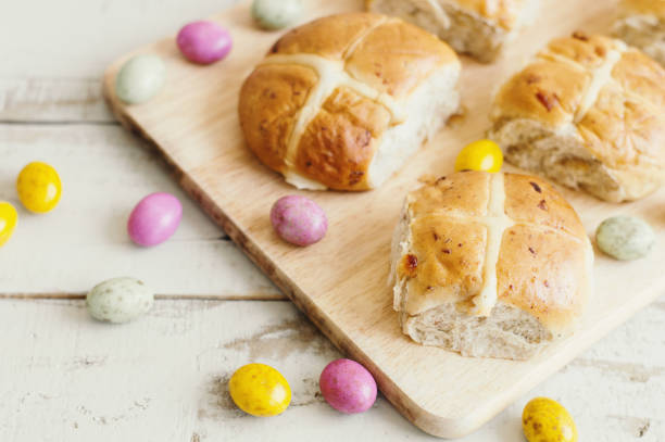 istock Traditional homemade hot cross buns and small colorful chocolate Easter eggs 1208583059