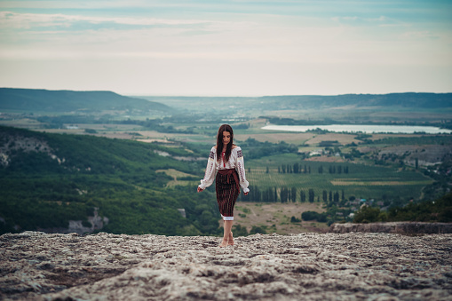 https://media.istockphoto.com/id/1208583746/photo/atractive-woman-in-traditional-romanian-costume-on-mountain-green-blurred-background-outdoor.jpg?b=1&s=170667a&w=0&k=20&c=Md9O_77T1cPOH8g2Bimr4rl0GLVNsQYsphL7Pl9t70o=