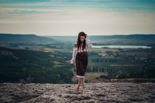 https://media.istockphoto.com/id/1208583753/photo/atractive-woman-in-traditional-romanian-costume-on-mountain-green-blurred-background-outdoor.jpg?b=1&s=170667a&w=0&k=20&c=fxAgtKynZHrmrbKTwnTv_iQtLTykWyCs9oOwMV76FjE=