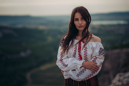 https://media.istockphoto.com/id/1208583903/photo/atractive-woman-in-traditional-romanian-costume-on-mountain-green-blurred-background-outdoor.jpg?b=1&s=170667a&w=0&k=20&c=slKzRw5UVJlIG4fyA5EDM2uJKDGsaGln1IRWFMT2MqQ=