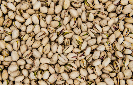 Roasted and salted pistachios top view as a background, texture