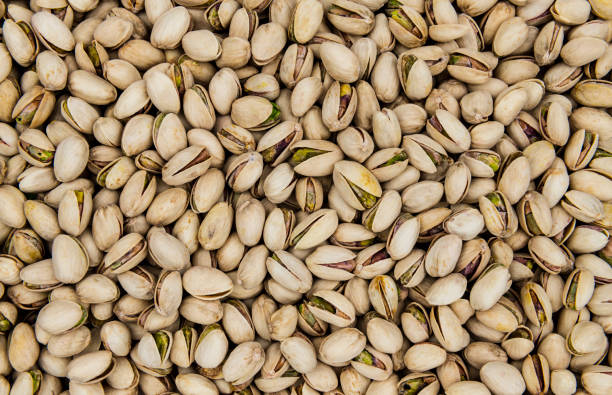 Texture of roasted pistachios as a background Roasted and salted pistachios top view as a background, texture nutcracker photos stock pictures, royalty-free photos & images