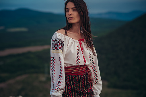 https://media.istockphoto.com/id/1208584187/photo/atractive-woman-in-traditional-romanian-costume-on-mountain-green-blurred-background-outdoor.jpg?b=1&s=170667a&w=0&k=20&c=yya1QyTh6vWtiPcaGeIRnFXqjO2Ut3z-hcIR_PqXj5Q=