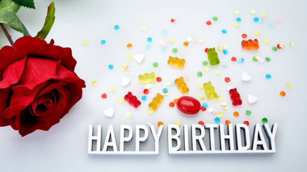 Colorful birthday cupcakes with gift and birthday card.Very shallow depth of field.