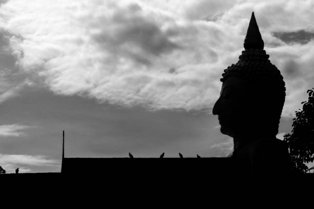 silhouette Buddha statue with sky background, abstract wallpaper.