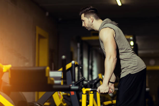 istock Handsome muscular man working out hard at gym 1208587850