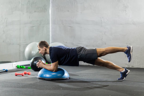 istock Fitness trainer in the gym shows exercises 1208587918