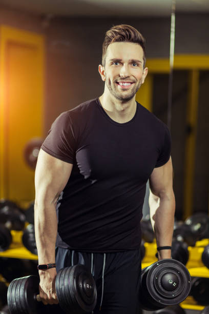 istock Handsome muscular man working out hard at gym 1208588954