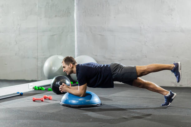istock Fitness trainer in the gym shows exercises 1208589065
